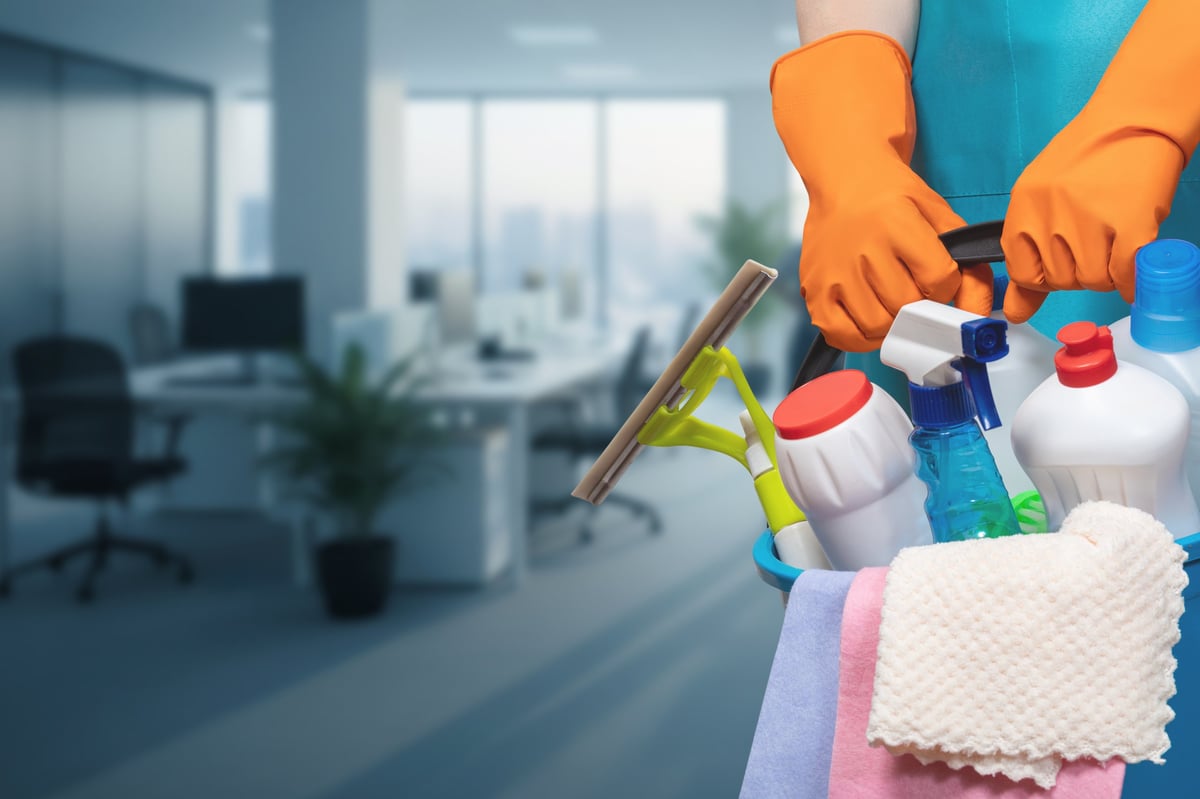 Cleaning team member preparing supplies before servicing an office space
